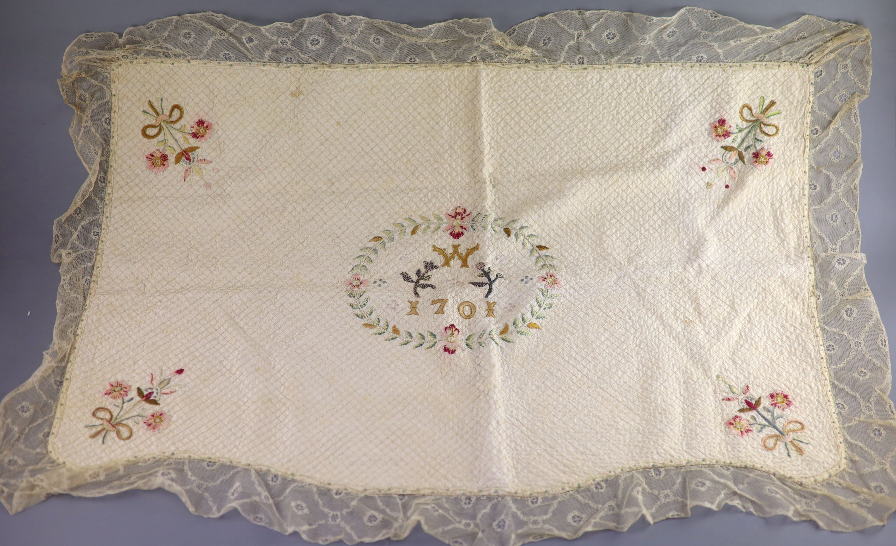 A silk coverlet embroidered 1701 with W initial as a centred cartouche,